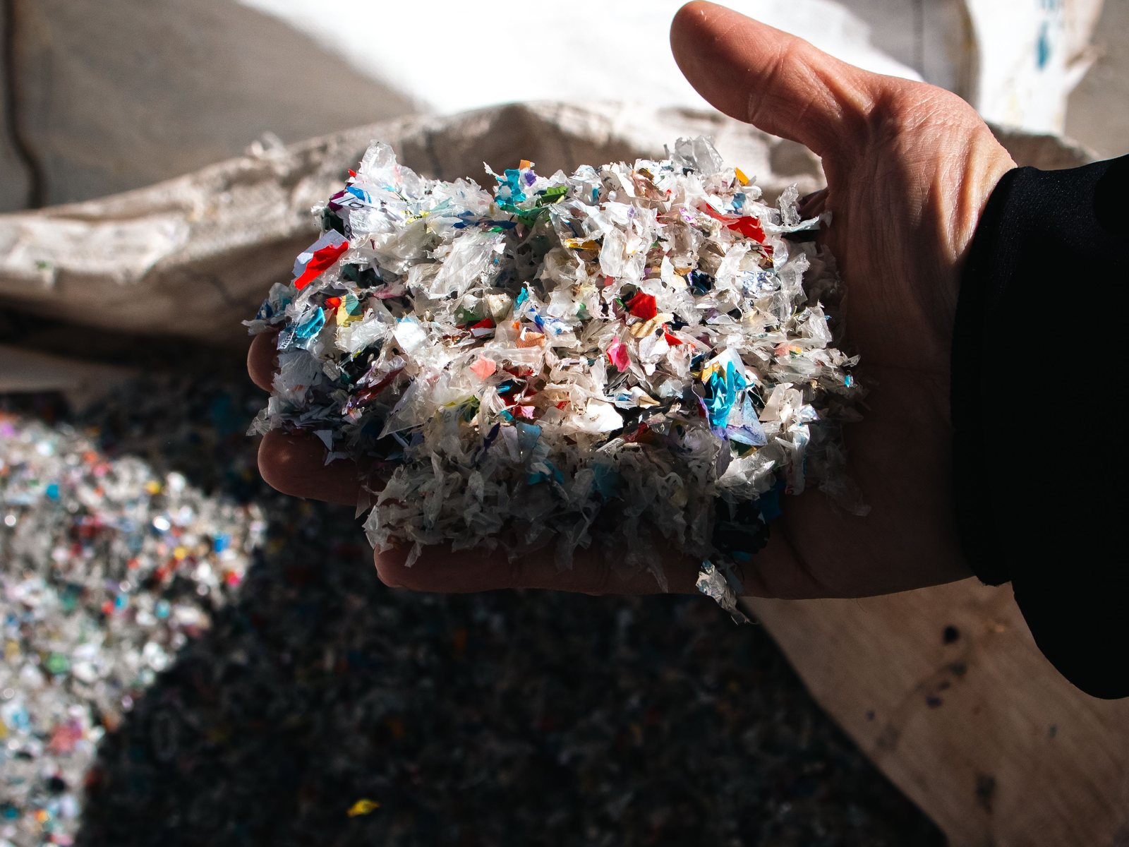 A handful of shredded mixed plastic fragments
